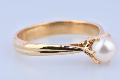 Bague solitaire en or (750 millièmes), ornée d’1 perle de culture blanche env. 0.5cm sertie de 6 griffes. 2