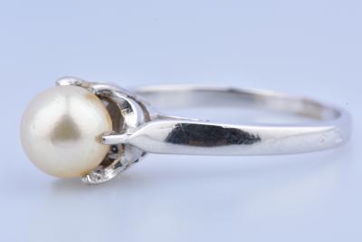 Bague solitaire en or blanc ornée d’une perle ronde blanche de 6.8 mm de diamètre sertie de 6 griffes. 2