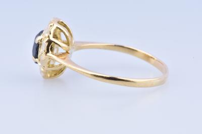 Solitaire ring in 18 carat yellow gold decorated with 1 0.2 carat oval cut sapphire and 10 zirconium oxides. 2