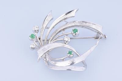 18 carat white gold brooch adorned with diamonds and emeralds. 2