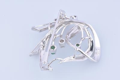 18 carat white gold brooch adorned with diamonds and emeralds. 2