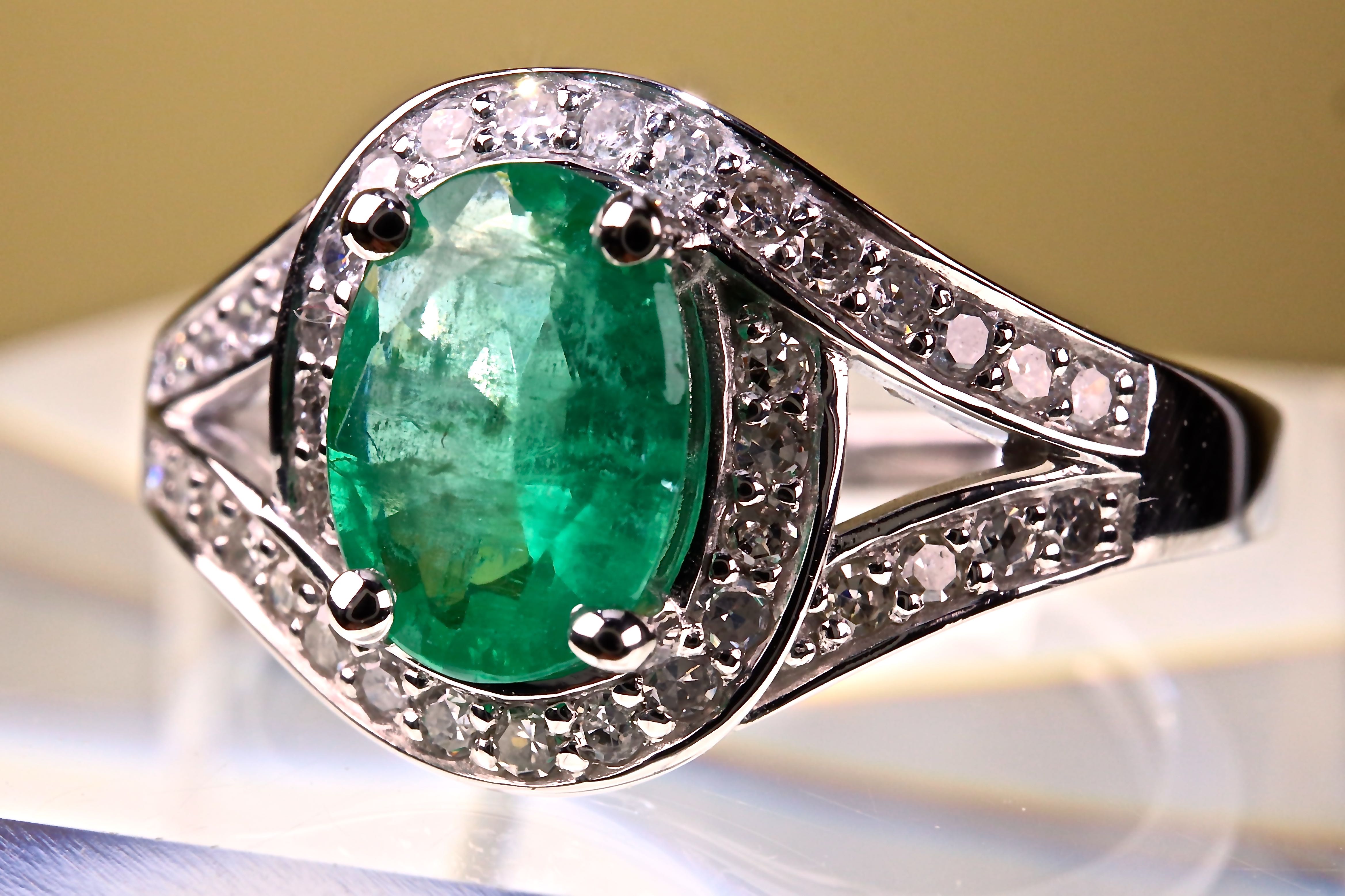 Oval Emerald ring of 0.81ct surrounded by 2 lines of 30 0.20ct diamonds ...
